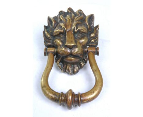 A large 19th Century lions mask door knocker
Naturalistically modelled face with a substantial loop knocker with a central ba