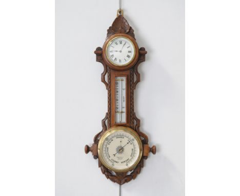A Victorian carved oak combined wall clock, thermometer and barometer
With a 8cm whtie dial with Roman numerals, key wound mo