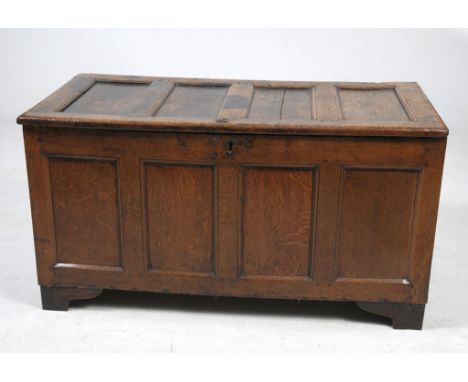 A 17th Century oak coffer
The rectangular hinged four panel top, panelled front and sides raised upon later bracket feet. 66x
