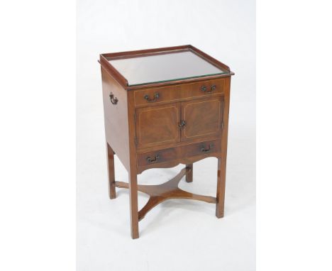 A George III inlaid mahogany wash-stand
With a raised three quarter gallery above a faux drawer with a pair of cupboard doors