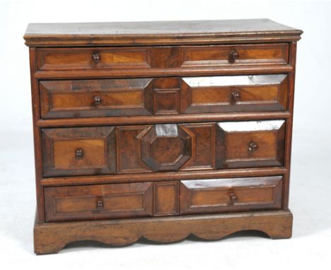A 17th Century oak and yew wood geometric chest of drawers, circa 1700
The rectangular single plank oak top incised with init