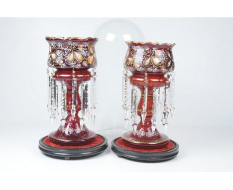 A pair of Victorian ruby glass table lustres 
Each of similar design with circular spreading bases extending to a basal knopp