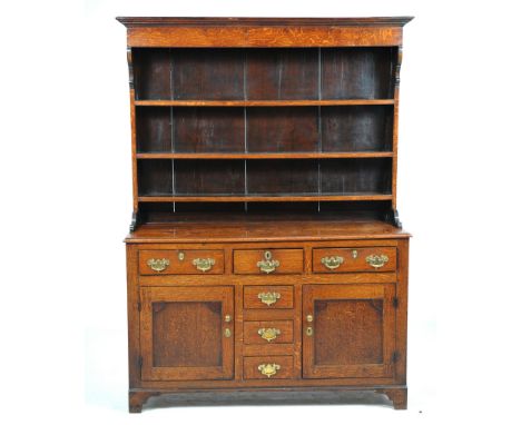 A late George III oak and mahogany high dresser
North Wales, the boarded rack with a cavetto and ovolu cornice above a plain 
