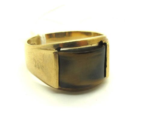 A 9ct Gold Tiger's Eye Panel Ring, signed JAYEM, the shaped rectangular panel, partially rubover set between tapered shoulder