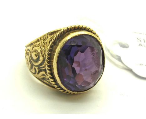 A Single Stone College Style Ring, the colour changing stone oval collet set to centre, between twisted border and scrolling 
