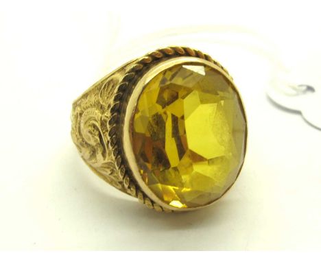 A Single Stone College Style Ring, oval collet set to centre between twisted border and scrolling relief tapered shoulders, s