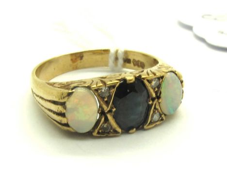 A Vintage 9ct Gold Three Stone Sapphire and Opal Ring, graduated oval collet set between decorative scroll setting and reeded
