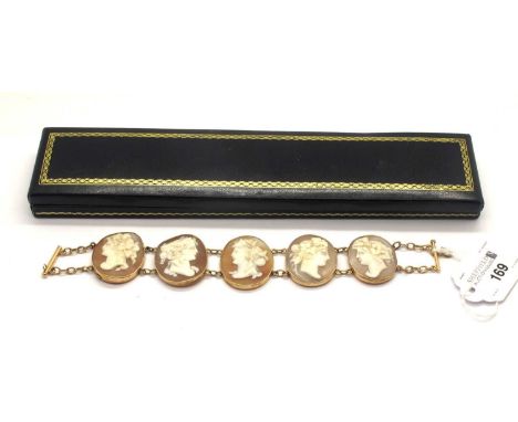 A XIX Century Shell Carved Cameo Panel Bracelet, composed of five oval collet panels, each depicting female profile with frui