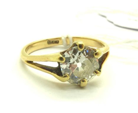 A Large XIX Century Single Stone Diamond Ring, the (irregular 7.5mm) old cut stone claw set, between bifurcated shoulders, st