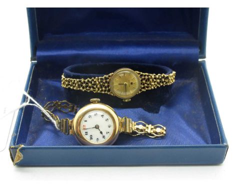 Tissot; A Vintage 9ct Gold Cased Ladies Wristwatch, the signed gilt dial with baton numerals, within textured finish border a
