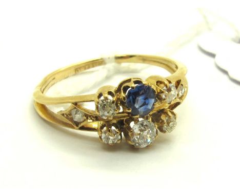 An Antique Style Sapphire and Diamond Ring, of bifurcated design, claw set with graduated old cut stones, between knife edge 