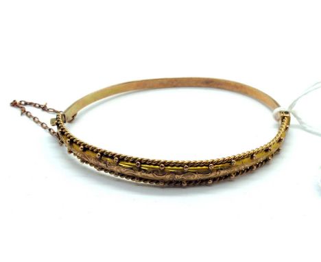 An Edwardian 9ct Gold Hinged Bangle, engraved and textured finish to the front, hinged to snap clasp with safety chain, Birmi