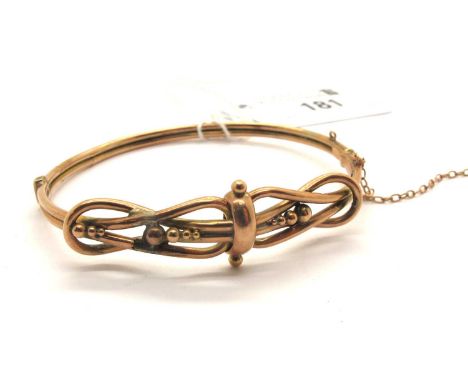 An Antique Knot Hinged Bangle, of openwork design with beaded decoration, to push clasp with safety chain (damages) (some sig