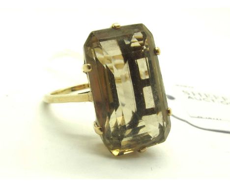 A Large Single Stone Dress Ring, six claw emerald cut set to centre, between uniform dainty band stamped "14K" "RC"(?) (finge