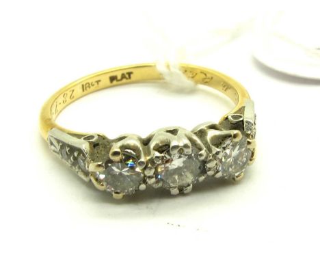 A Vintage Three Stone Diamond Ring, claw set with brilliant cut stones, between diamond set shoulders, stamped "18ct Plat" an