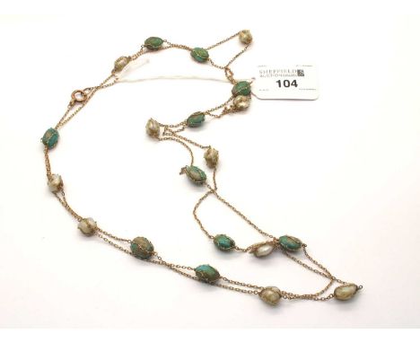 Murrle Bennett &amp; Co; An Arts &amp; Crafts Baroque Pearl and Turquoise Long Chain, to rose colour bolt ring stamped "9ct",