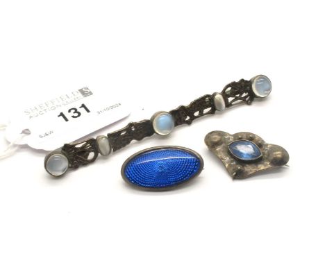 An Arts &amp; Crafts Moonstone and Pearl Set Elongated Bar Brooch, oval and circular collet set, 9.7cm long; A J.W. Hallmarke