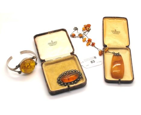 An Art Deco Style Amber Colour Pendant, the fine chain with tumbled amber colour bead spacers, clasp stamped "875", approxima