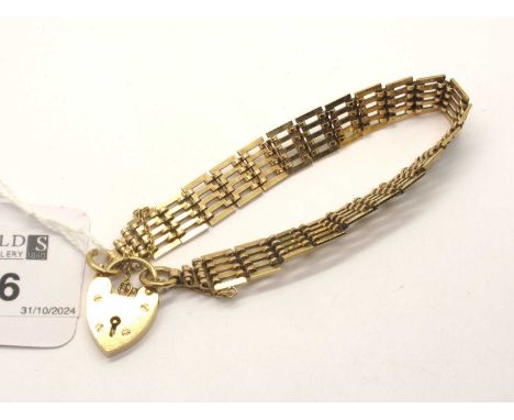 A 9ct Gold Gate Bracelet, of uniform design, with engine turned openwork links, to heart shape padlock style clasp (14.5grams