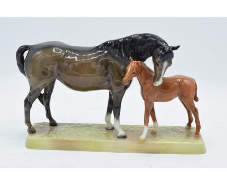 Beswick Mare and Foal on base: Beswick brown mare with Chestnut foal on ceramic grass base 1811. In good condition with no ob