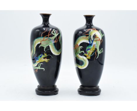 Pair of Japanese cloisonné enamel vases showing coloured dragons on a black background.  No obvious damage noted. Standing 18