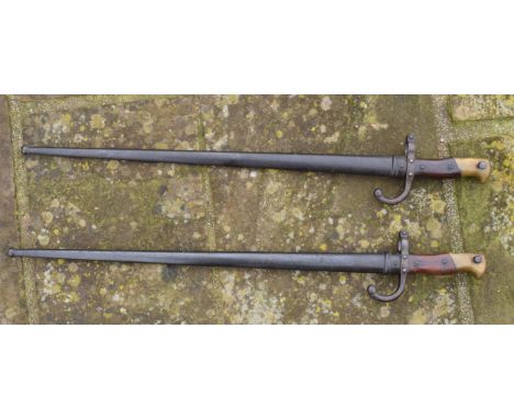 A pair of antique French bayonets (2). One with inscription 'Mre D'Armes de Tulle Janvier 1880' with metal scabbard with matc