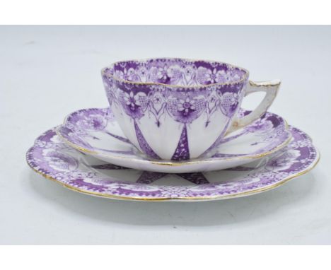 Wileman and Co Foley china (pre Shelley) trio to consist of a shaped cup, saucer and side plate (3) with a purple design. In 