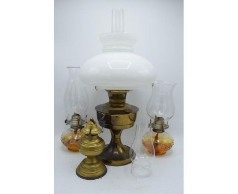 A collection of vintage oil lamps to include brass examples with associated shades and chimneys (4). NO POSTAGE. In good cond