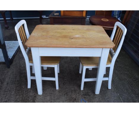 A 20th century pine-topped kitchen table with a single draw and 2 dining chairs decorated with a vintage / shabby chic design
