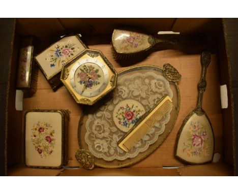 A 20th century ornate gilt metal dressing table set to include a tray, brushes, clock, trinkets etc. Generally good condition