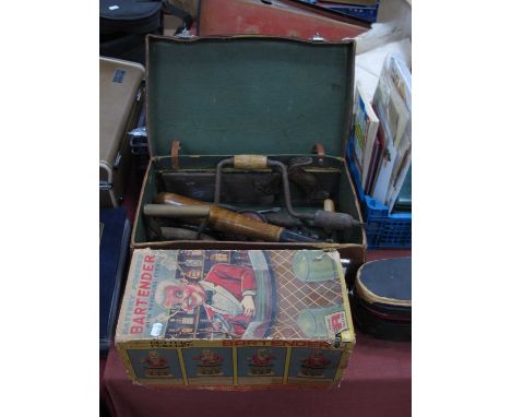 A 'battery powered bartender with revolving eyes' complete with original box together with a suitcase holding a vintage woode