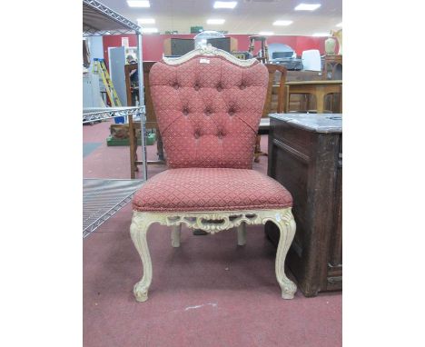 A XX Century White Painted Nursing Chair, with shaped top rail, upholstered button back and seat, on cabriole legs.