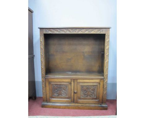 XX Century Oak Bookcase, with a carved frieze carved panel doors, on a plinth base 79cm wide.