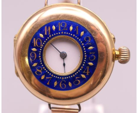 A 14 ct gold and enamel half hunter wristwatch on a 9 ct gold bracelet. 4 cm wide. 41.3 grammes total weight. 