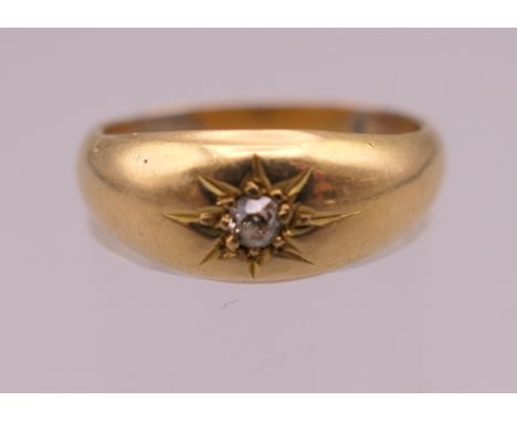 An unmarked gold gypsy set diamond solitaire ring. Ring size O. 3.1 grammes total weight.