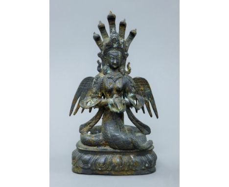 A Chinese bronze winged figure. 26 cm high.