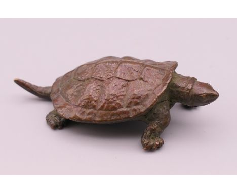 A bronze model of a tortoise.  6 cm long. 