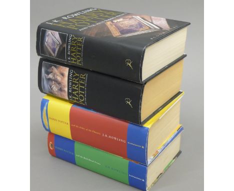 Four J K Rowling first edition Harry Potter books, with dust covers.