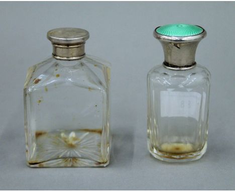 A green enamel and silver top scent bottle, together with another silver top scent bottle. The former 9.5 cm high.