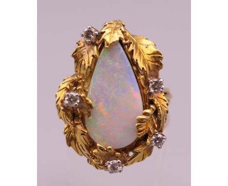 An 18 ct gold opal and diamond ring. Ring size N/O (with sizer). 13.9 grammes total weight.