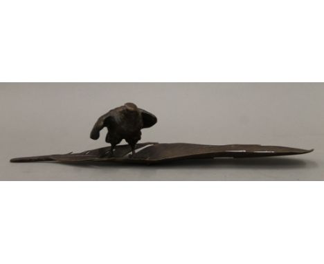 An antique Vienna cold painted bronze eagle standing on a large feather, stamped Gestutz and numbered. 33.5 cm long,