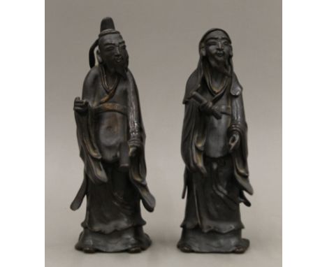 A pair of Chinese bronze models of sages. The largest 25 cm high.