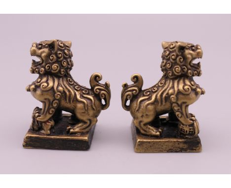 A pair of small gilt bronze Chinese seals formed as dogs-of fo.  Each 3 cm high. 