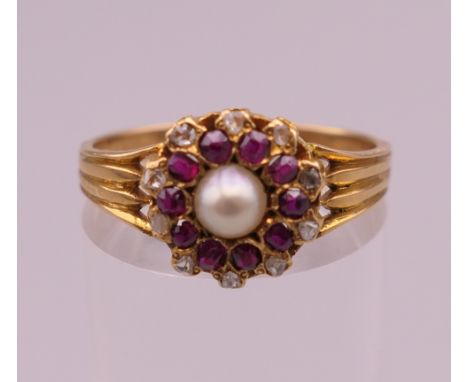 A gold, probably 18 ct gold, pearl, ruby and diamond ring. Ring size O. 3.1 grammes total weight.