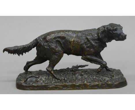 A bronze model of a retriever, signed P J Mene. 21 cm long.