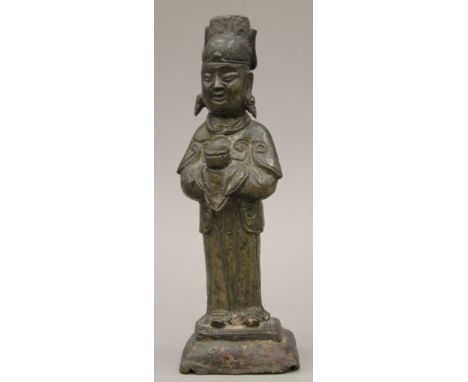 A Chinese Ming Dynasty bronze figure of an attendant. 21.5 cm high.