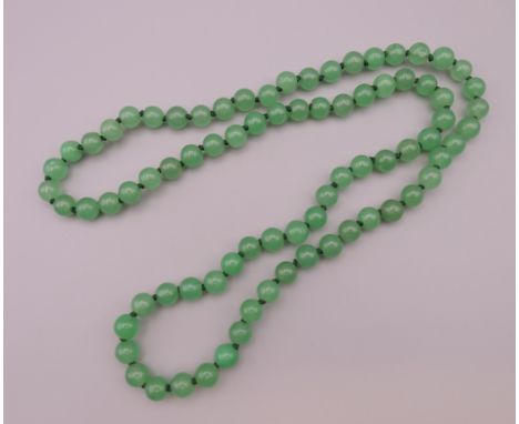 A jade bead necklace. Approximately 72 cm long. 