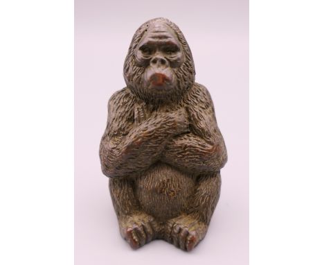 A bronze model of a gorilla.  5 cm high. 