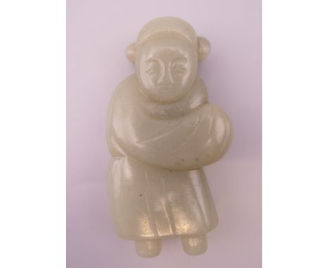 A celadon jade figure of a girl. 7.5 cm high. 