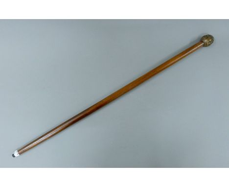 A walking stick with a carved buddha head formed handle. 92 cm high.